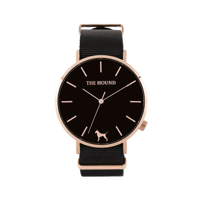 Rose gold and black watch with a soft black nato band and rose gold black buckle designed by THE HOUND, styled done up and shot from a front on angle.