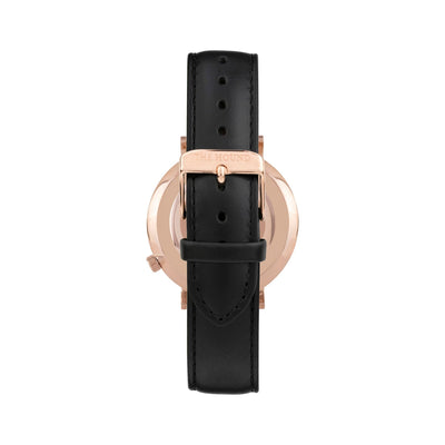 Rose gold and white watch with a stitched black genuine leather band and rose gold black buckle designed by THE HOUND, styled done up and shot from behind.