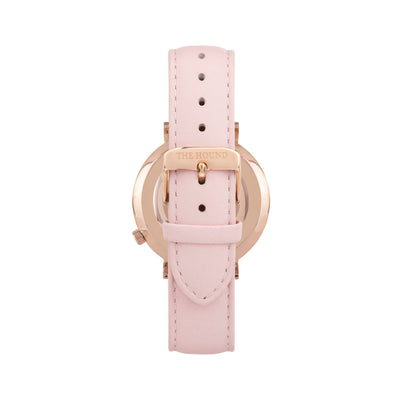 Rose gold and black watch with a stitched blush pink genuine leather band and rose gold black buckle designed by THE HOUND, styled done up and shot from behind.