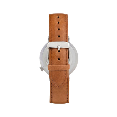 Silver and white watch with a stitched tan genuine leather band and silver black buckle designed by THE HOUND, styled done up and shot from behind.