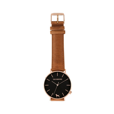 Rose gold and black watch with a stitched tan genuine leather band and rose gold black buckle designed by THE HOUND, styled flat and shot from above.